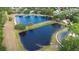 Aerial view of community featuring two picturesque ponds surrounded by lush landscaping and beautiful homes at 1003 Chesterfield Cir, Winter Springs, FL 32708