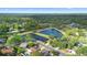 Aerial view of neighborhood, featuring community ponds and mature trees at 1003 Chesterfield Cir, Winter Springs, FL 32708
