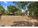 Large, private backyard offers a serene setting with mature trees, a lawn, and a cozy home at 1003 Chesterfield Cir, Winter Springs, FL 32708