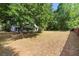 Expansive backyard featuring mature trees and ample space for outdoor activities and gardening at 1003 Chesterfield Cir, Winter Springs, FL 32708