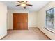 Neutral bedroom with a ceiling fan, closet, and window for natural light at 1003 Chesterfield Cir, Winter Springs, FL 32708