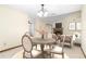 Cozy dining area featuring a round table, four chairs, and a view of a fireplace and living space at 1003 Chesterfield Cir, Winter Springs, FL 32708