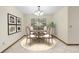 Elegant dining area features a round table, four chairs, natural light, and classic decor elements at 1003 Chesterfield Cir, Winter Springs, FL 32708
