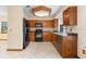 Functional kitchen with wooden cabinets and modern black appliances at 1003 Chesterfield Cir, Winter Springs, FL 32708