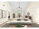 Bright living room featuring a modern sofa, high ceilings, and neutral decor, creating an inviting atmosphere at 1003 Chesterfield Cir, Winter Springs, FL 32708