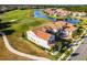 Stunning aerial view of home with tile roof on a waterfront golf course lot at 10196 Bucklow Hill Dr, Orlando, FL 32832