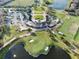 Aerial view of community center with golf course, parking lot, and bodies of water nearby at 10196 Bucklow Hill Dr, Orlando, FL 32832