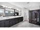 Bathroom featuring double vanity, mirrors and access to a sauna at 10196 Bucklow Hill Dr, Orlando, FL 32832
