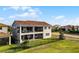 The exterior backyard of home features a covered porch and balcony at 10196 Bucklow Hill Dr, Orlando, FL 32832