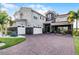 Stately two-story home featuring a three-car garage and paved driveway with beautiful landscaping at 10196 Bucklow Hill Dr, Orlando, FL 32832