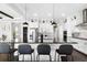 Kitchen with large island and seating, white cabinetry and stainless appliances at 10196 Bucklow Hill Dr, Orlando, FL 32832