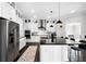 Bright kitchen with stainless appliances, pendant lighting and island with bar seating at 10196 Bucklow Hill Dr, Orlando, FL 32832