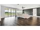 Bright living room with dark accent wall, hardwood floors, and floor to ceiling glass doors overlooking the backyard at 10196 Bucklow Hill Dr, Orlando, FL 32832