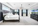Bright main bedroom with tray ceilings, a large bed, and ample natural light at 10196 Bucklow Hill Dr, Orlando, FL 32832