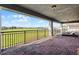 Covered outdoor patio overlooking beautiful lush green golf course and serene waterfront at 10196 Bucklow Hill Dr, Orlando, FL 32832