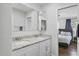 Bathroom features a double-sink vanity with granite countertop and a view of the bedroom at 1020 Grove St # 29, Maitland, FL 32751