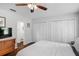 Well-lit bedroom showcasing hardwood floors, a ceiling fan, closets, and en-suite bathroom access at 1020 Grove St # 29, Maitland, FL 32751