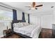 Light and airy bedroom featuring wood floors, a ceiling fan, and double door closets at 1020 Grove St # 29, Maitland, FL 32751