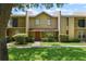 Inviting townhouse with a well-maintained lawn, garden, and walkway leading to a covered front entrance at 1020 Grove St # 29, Maitland, FL 32751