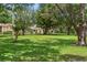 Expansive green space surrounded by mature trees and the exteriors of multiple townhomes at 1020 Grove St # 29, Maitland, FL 32751