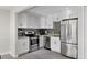 Updated kitchen featuring white cabinets, stainless steel appliances, and modern gray tile flooring at 1020 Grove St # 29, Maitland, FL 32751