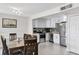 Bright dining and kitchen area features white cabinets, stainless appliances, and gray tile backsplash at 1020 Grove St # 29, Maitland, FL 32751