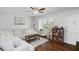 Cozy living room with wood floors, white sectional sofa, and a window with natural light at 1020 Grove St # 29, Maitland, FL 32751