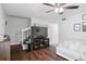 Open living room with hardwood floors, a flat-screen TV, and staircase to the upper level at 1020 Grove St # 29, Maitland, FL 32751