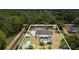 Expansive aerial view showcases a pool, screened patio, and lush surroundings of a beautiful home and grounds at 10528 Old Dade City Rd, Lakeland, FL 33810