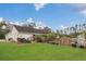Spacious backyard featuring a lush lawn, garden area, and partial view of the home's exterior at 10528 Old Dade City Rd, Lakeland, FL 33810