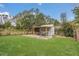 This backyard features a manicured lawn and shaded seating at 10528 Old Dade City Rd, Lakeland, FL 33810