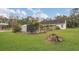 Expansive backyard view with lush green grass, garden shed, and partial home view at 10528 Old Dade City Rd, Lakeland, FL 33810