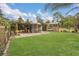 This backyard features a manicured lawn and chicken coop at 10528 Old Dade City Rd, Lakeland, FL 33810