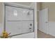 This bathroom features a glass enclosed shower with a white tile surround at 10528 Old Dade City Rd, Lakeland, FL 33810