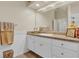 This bathroom features a white vanity, a large mirror, and neutral-toned walls at 10528 Old Dade City Rd, Lakeland, FL 33810