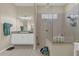 Bathroom featuring a walk-in shower, vanity with double sinks, and a framed mirror at 10528 Old Dade City Rd, Lakeland, FL 33810