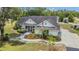 Charming single-story home featuring a manicured lawn, landscaped flowerbeds, and a welcoming front porch at 10528 Old Dade City Rd, Lakeland, FL 33810