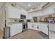 View of a kitchen with stainless steel appliances, white cabinets, tile flooring and bright natural lighting at 10528 Old Dade City Rd, Lakeland, FL 33810