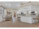 Bright kitchen featuring tile floors, breakfast bar, and dining area with a farmhouse-style design at 10528 Old Dade City Rd, Lakeland, FL 33810