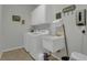 Laundry room with a sink, storage cabinets, and a front-load washer and dryer at 10528 Old Dade City Rd, Lakeland, FL 33810