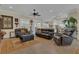 Comfortable living room with leather furniture, ceiling fan, and tile flooring at 10528 Old Dade City Rd, Lakeland, FL 33810