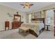 Nautical themed main bedroom with wooden furniture, a ceiling fan, and curtains that add to a beach-style vibe at 10528 Old Dade City Rd, Lakeland, FL 33810