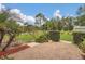Brick patio with a manicured garden and lush landscaping around the yard at 10528 Old Dade City Rd, Lakeland, FL 33810