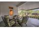 This covered patio includes four chairs and a table with green and cream colored cushions at 10528 Old Dade City Rd, Lakeland, FL 33810