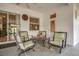 This covered patio includes four chairs and a table with green and cream colored cushions at 10528 Old Dade City Rd, Lakeland, FL 33810