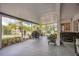 This screened-in patio overlooks a yard with a grill and tropical foliage at 10528 Old Dade City Rd, Lakeland, FL 33810