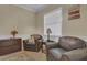 Cozy sitting room featuring comfortable chairs, a window, and soft lighting at 10528 Old Dade City Rd, Lakeland, FL 33810