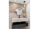 Bathroom with a floating vanity, modern round mirror and decorative pendant lighting at 1113 Black Acre Trl, Winter Springs, FL 32708