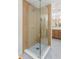 Modern bathroom showcasing a glass shower, patterned tile flooring, and a stylish double sink vanity with gold hardware at 1113 Black Acre Trl, Winter Springs, FL 32708