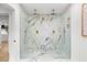 Modern bathroom with a luxurious glass-enclosed shower and marble accents and dual shower heads at 1113 Black Acre Trl, Winter Springs, FL 32708